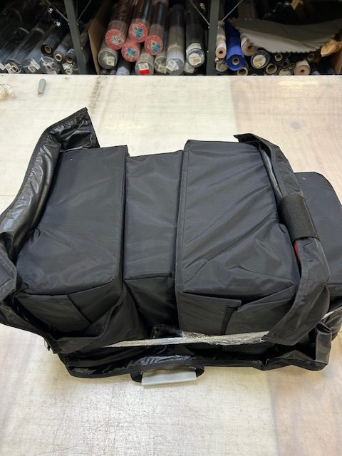 https://www.sutherlandsewing.com/wp-content/uploads/2025/08/Bundled-padded-automotive-dunnage-cover-rotated.jpg