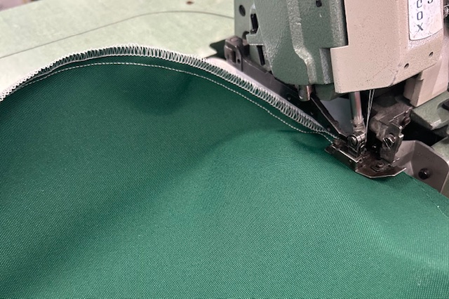 https://www.sutherlandsewing.com/wp-content/uploads/2025/08/website-Green-Fabric-White-Stitch.jpg